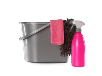 Photo of Plastic bucket with different cleaning supplies isolated on white