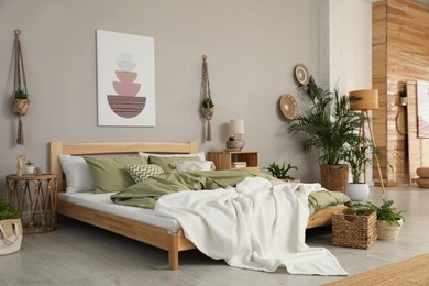 Photo of Stylish room interior with comfortable wooden bed