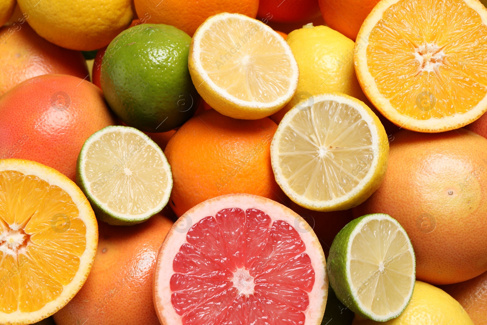 Photo of Different fresh citrus fruits as background, above view