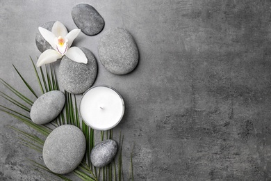 Photo of Spa stones and beautiful flower on grey background