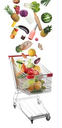 Image of Market assortment. Different products falling into shopping cart on white background