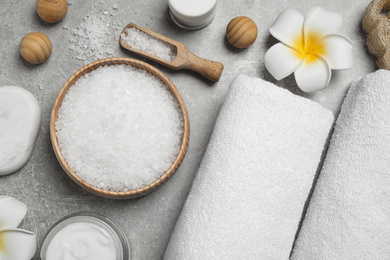 Photo of Flat lay composition with cosmetics and sea salt on grey marble table. Spa treatment