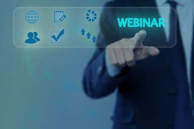 Image of Webinar. Businessman using virtual screen with icons on color background, closeup