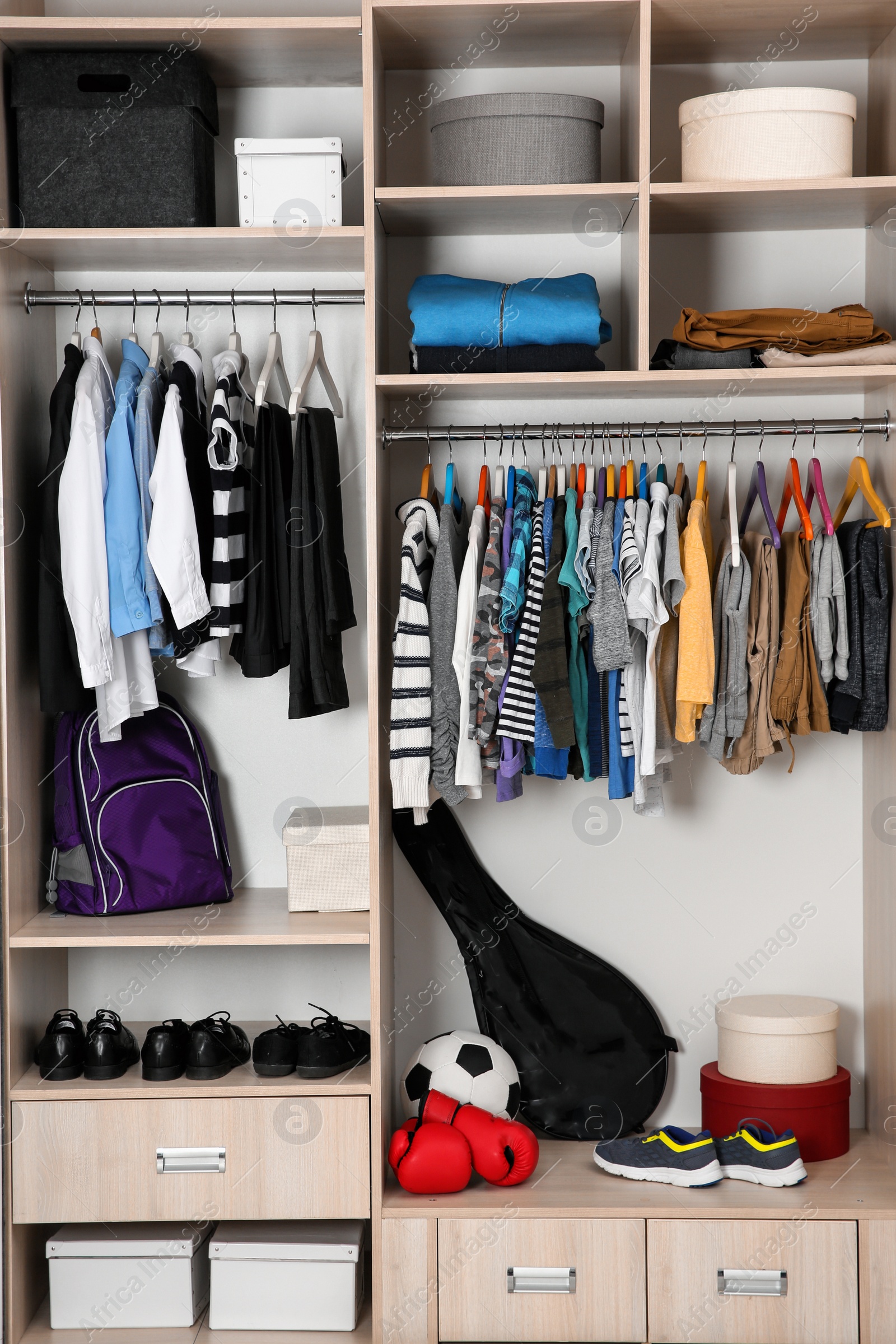 Photo of Wardrobe with stylish boy's clothes hanging on rack