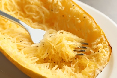 Photo of Plate with spaghetti squash and fork, closeup