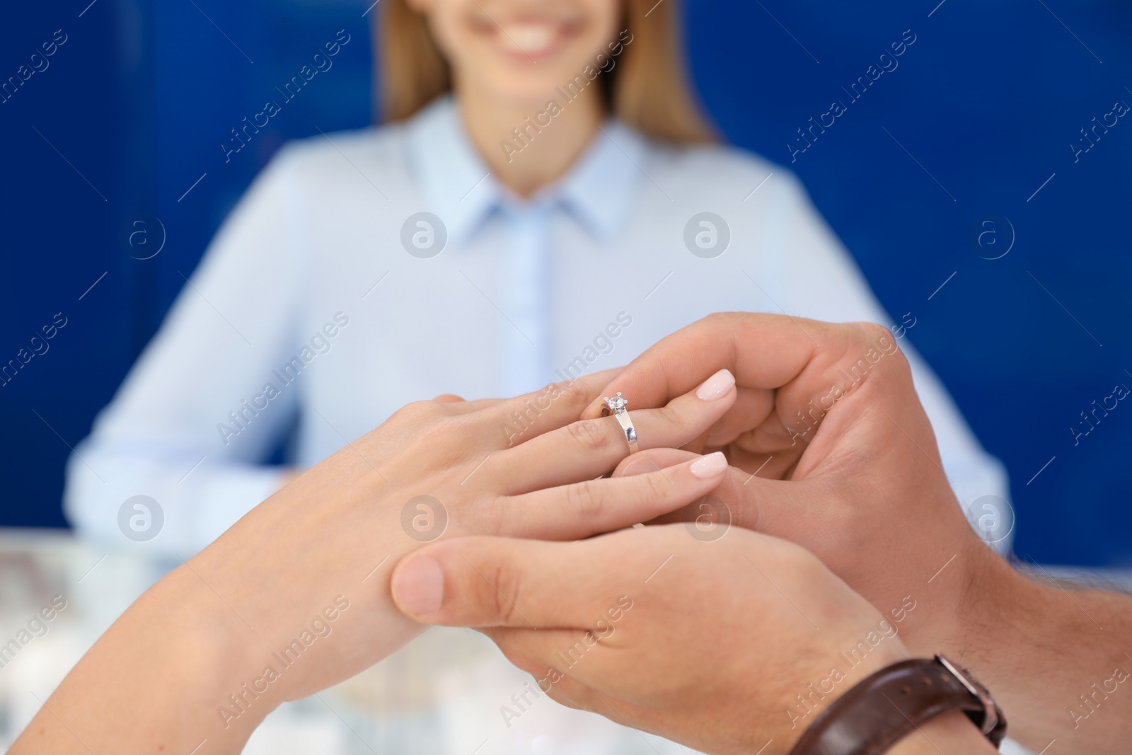 Couple choosing engagement ring in jewelry store, closeup Photo of Couple choosing engagement ring in jewelry store, closeup
