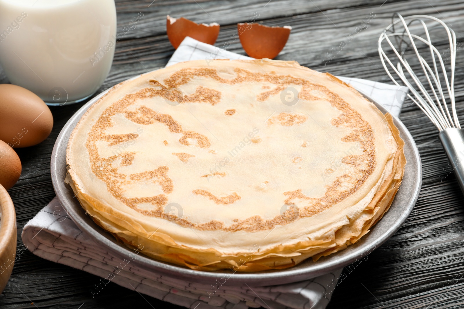 Photo of Plate with thin pancakes on table