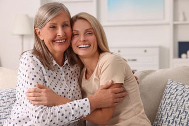 Happy mature mother and her daughter at home