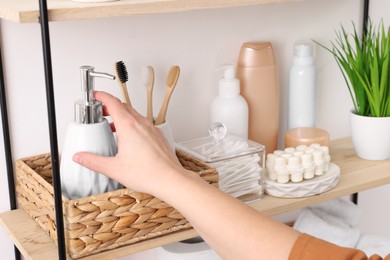 Photo of Bath accessories. Woman organizing personal care products indoors, closeup