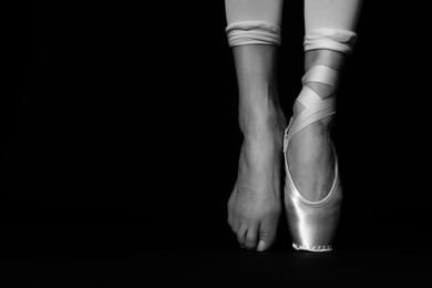 Image of Ballerina in pointe shoe dancing, closeup with space for text. Black and white effect