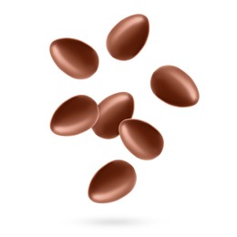 Image of Many chocolate eggs falling on white background