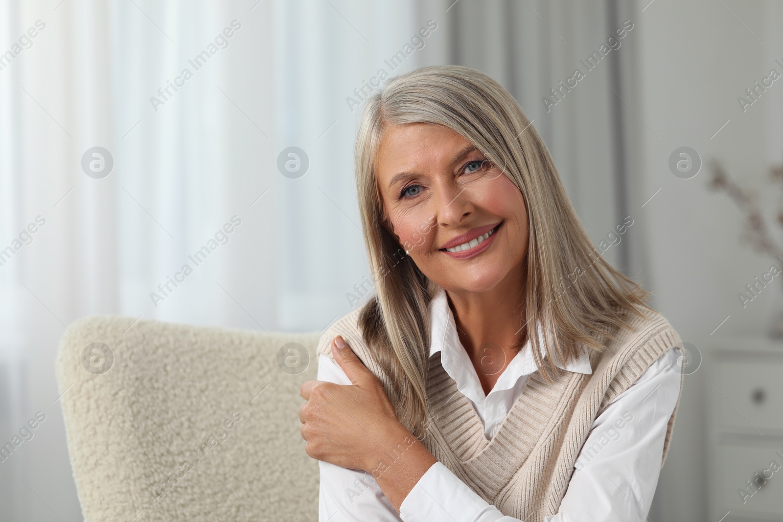 Photo of Portrait of beautiful middle aged woman at home, space for text