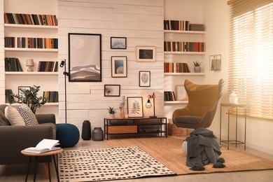 Photo of Cozy home library interior with comfortable furniture and collection of different books on shelves