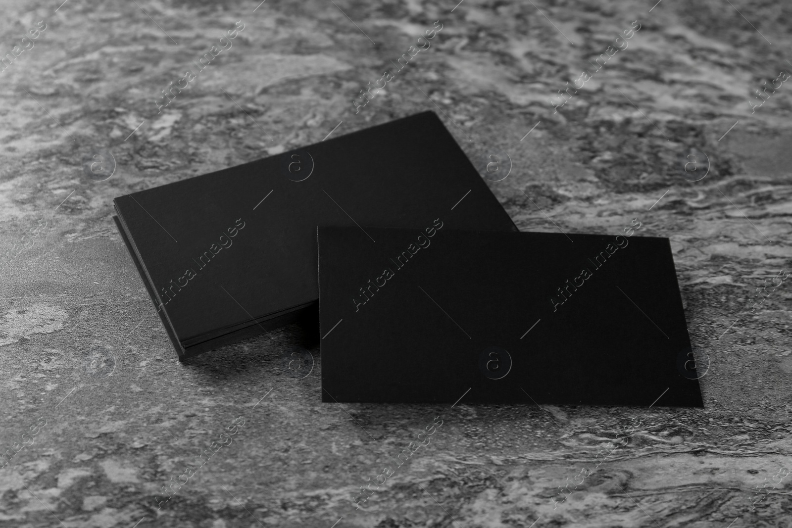 Photo of Blank black business cards on grey background. Mockup for design