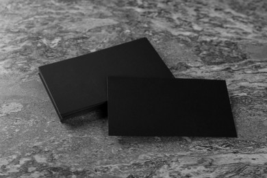 Blank black business cards on grey background. Mockup for design