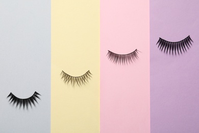 Photo of False eyelashes on color background, flat lay