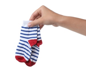 Photo of Woman holding pair of cute child socks on white background, closeup