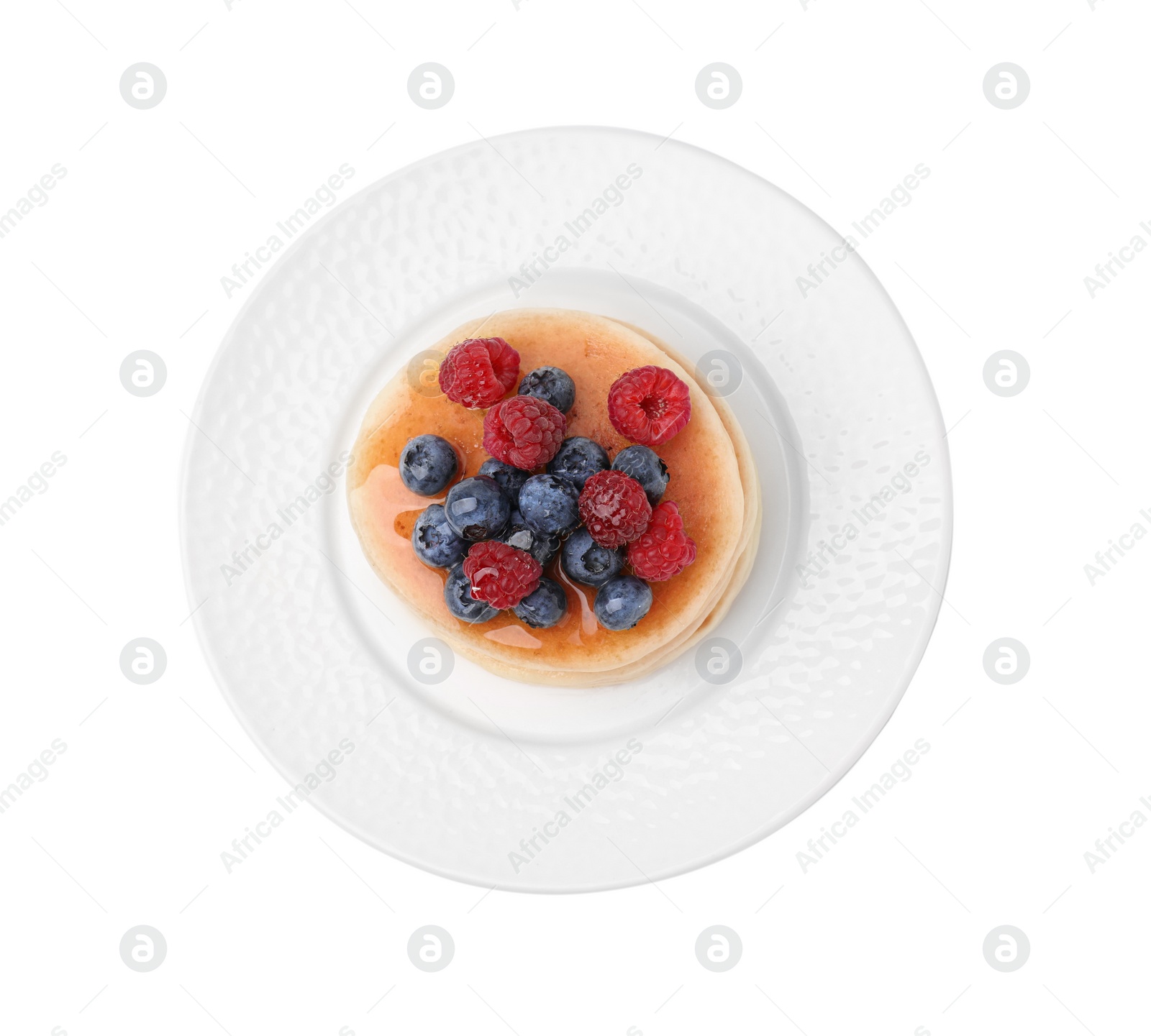 Photo of Delicious pancakes with berries and honey isolated on white, top view