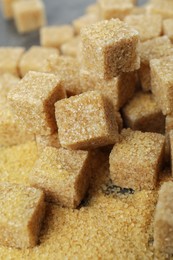 Photo of Brown sugar cubes on table, closeup view