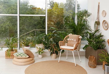 Room interior with stylish furniture and green plants