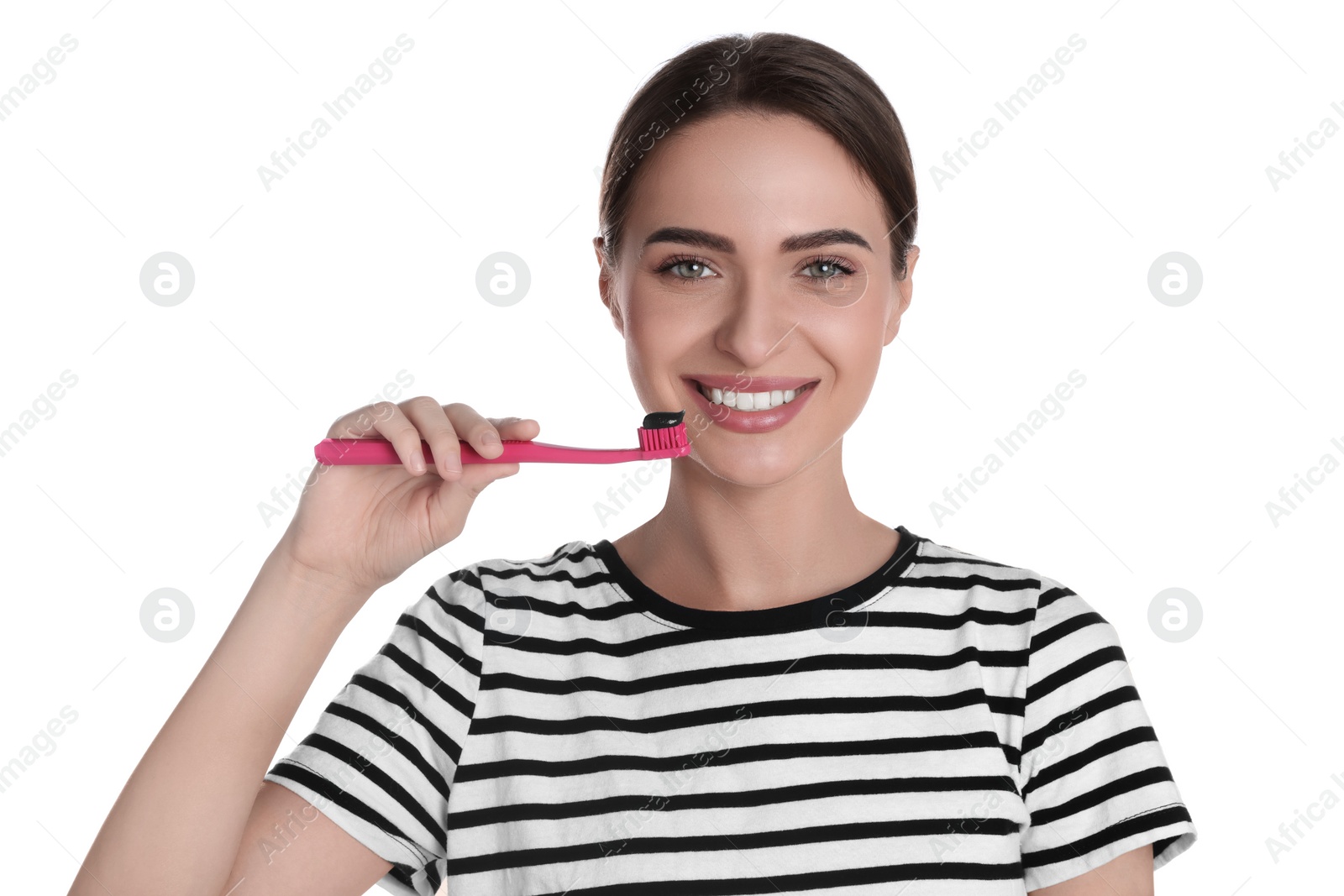 Photo of Young woman holding brush with charcoal toothpaste on white background