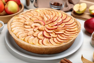 Tasty apple pie on white wooden table, closeup