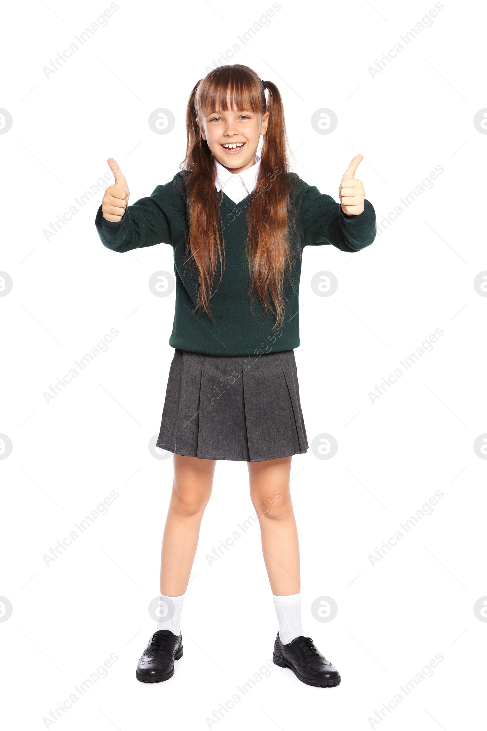 Photo of Little girl in stylish school uniform on white background