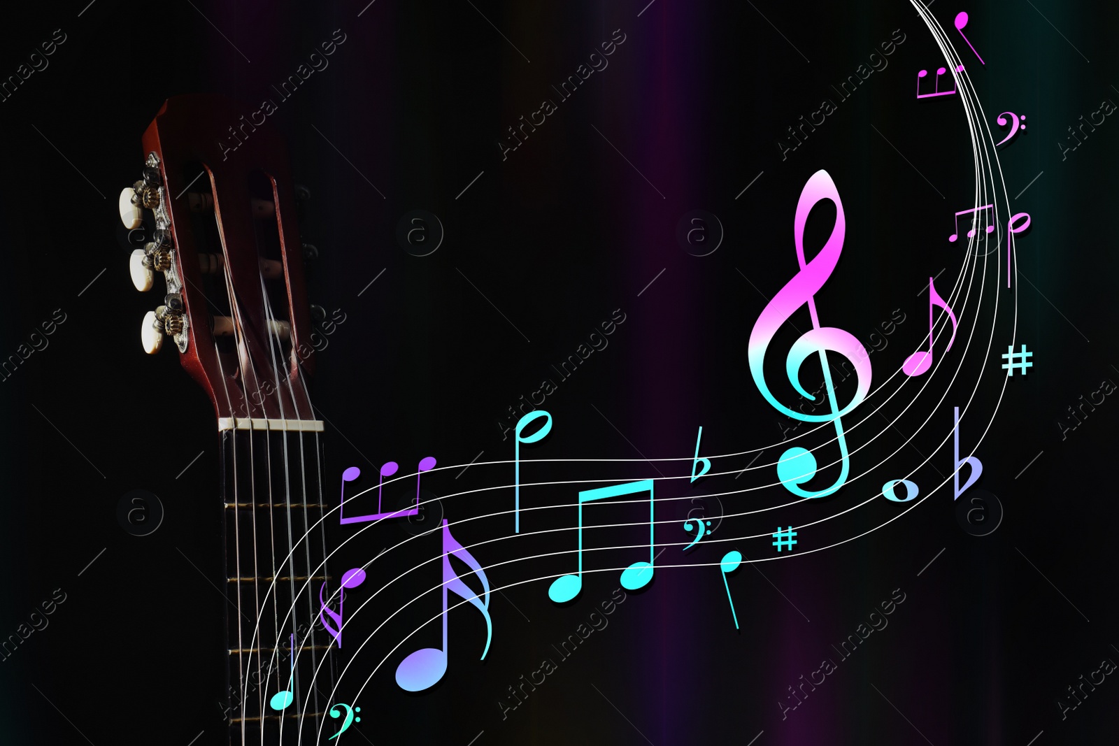 Image of Staff with music notes and symbols flowing from acoustic guitar neck on dark background, closeup