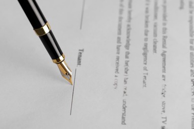 Photo of Writing on document with fountain pen, closeup. Notary contract
