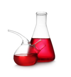 Photo of Laboratory glassware with red liquid on white background