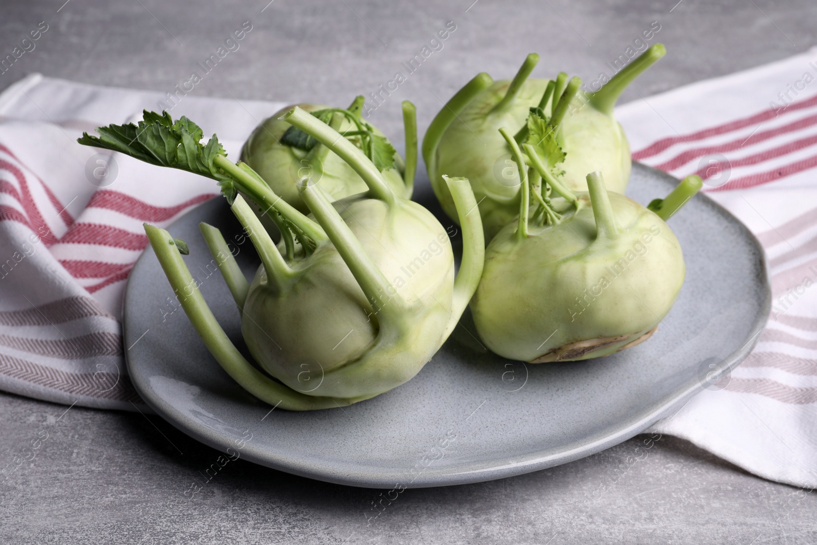 Photo of Whole ripe kohlrabi plant on grey table