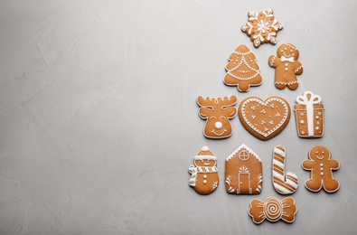 Photo of Christmas tree shape made of delicious gingerbread cookies on light table, flat lay. Space for text