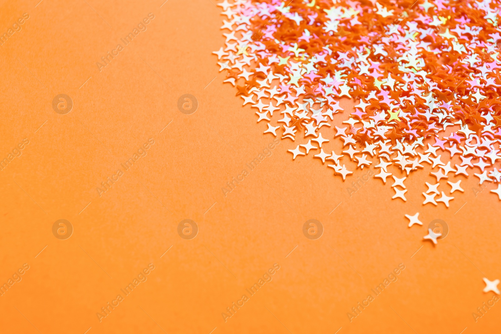 Photo of Shiny bright glitter on pink background. Space for text