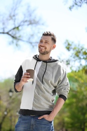 Photo of Portrait of young man with cup of coffee outdoors