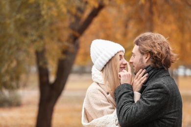 Photo of Young romantic couple in park on autumn day