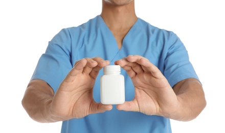 Photo of Male doctor holding pill bottle on white background, closeup with space for text. Medical object