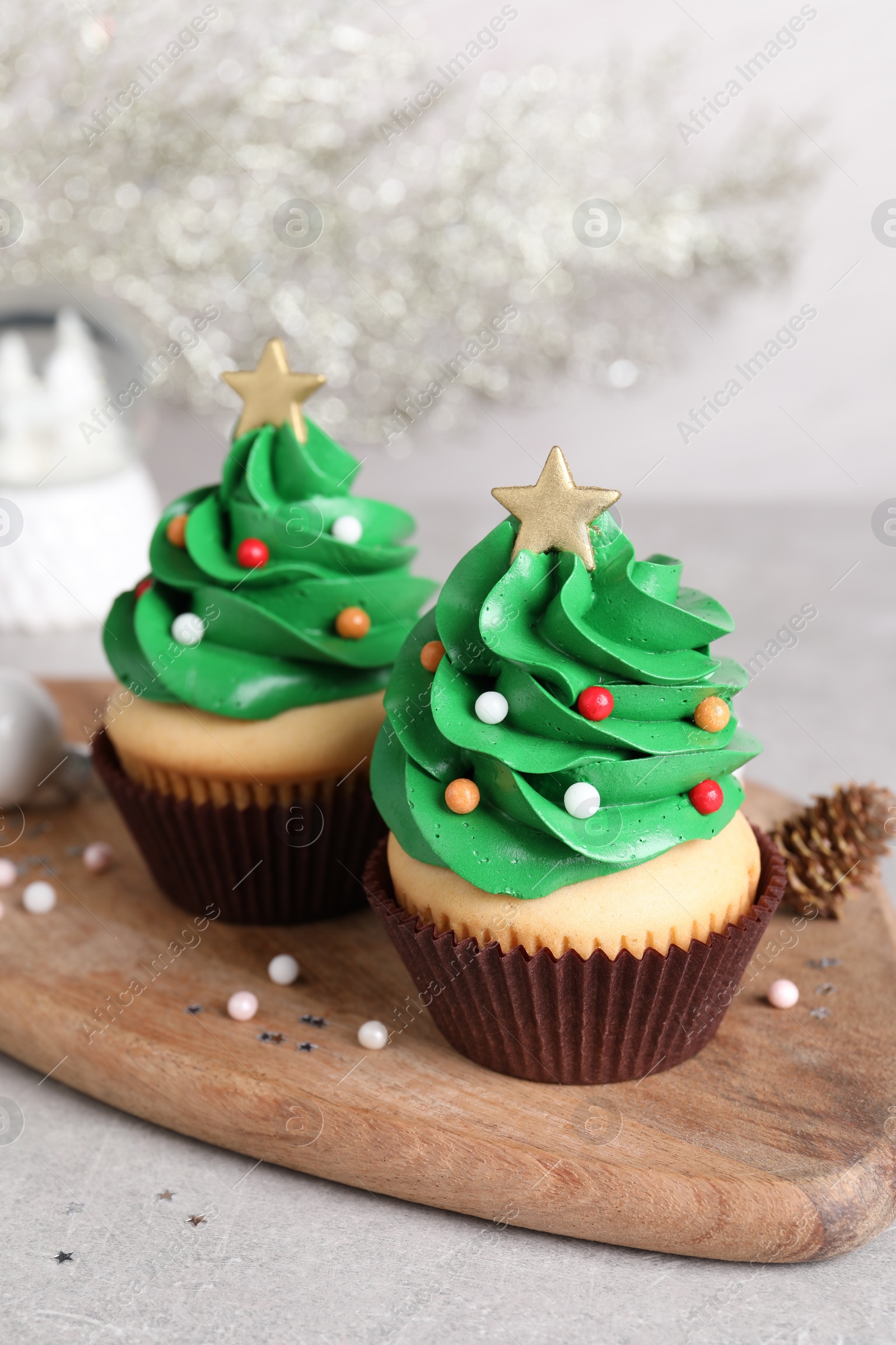 Photo of Christmas tree shaped cupcakes on light grey table