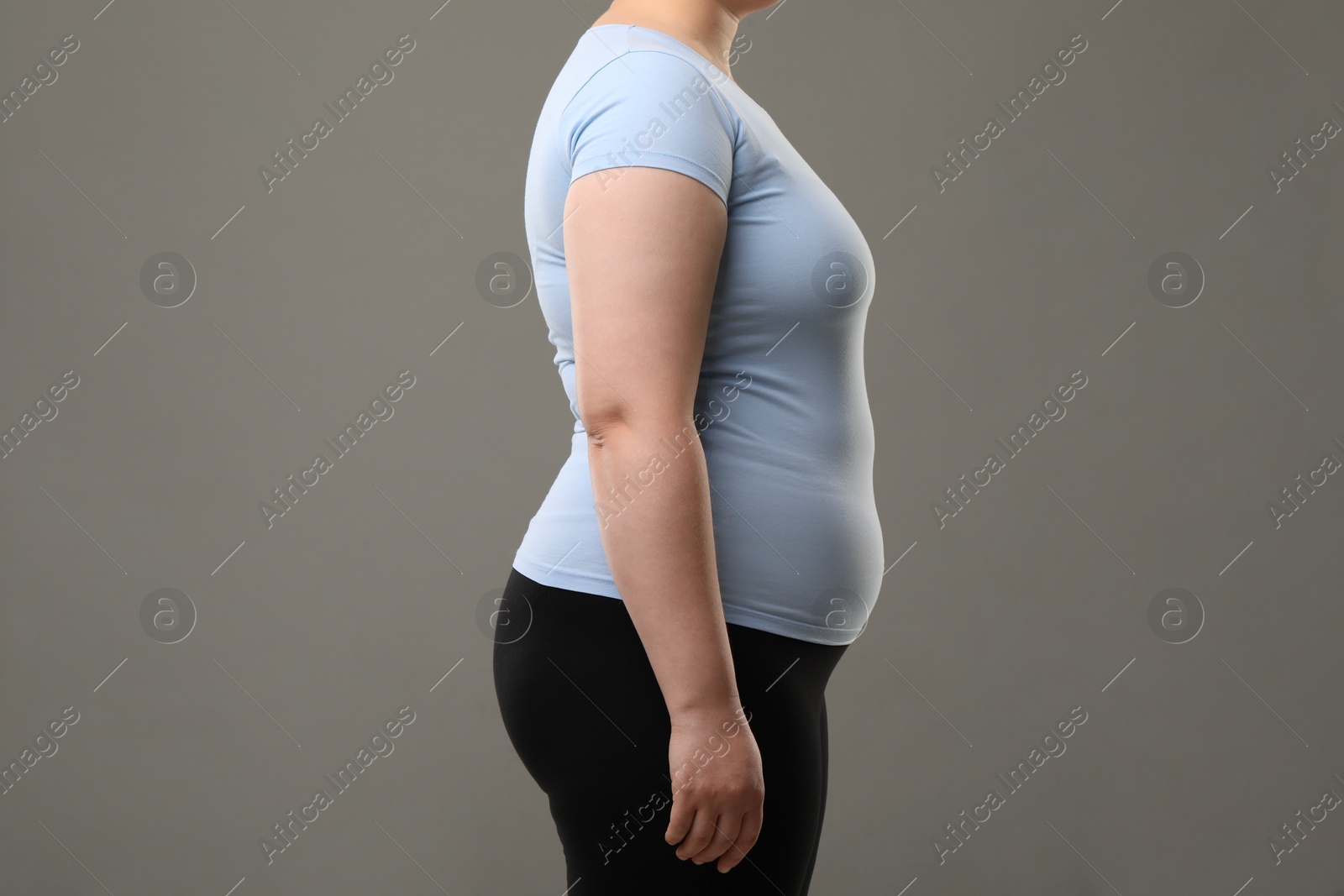 Photo of Overweight woman on grey background, closeup view