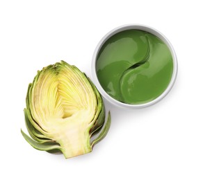 Photo of Package of under eye patches and artichoke on white background, top view. Cosmetic product