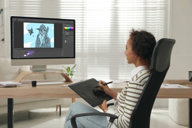 Image of African American animator using graphic tablet and computer. Illustration on screen