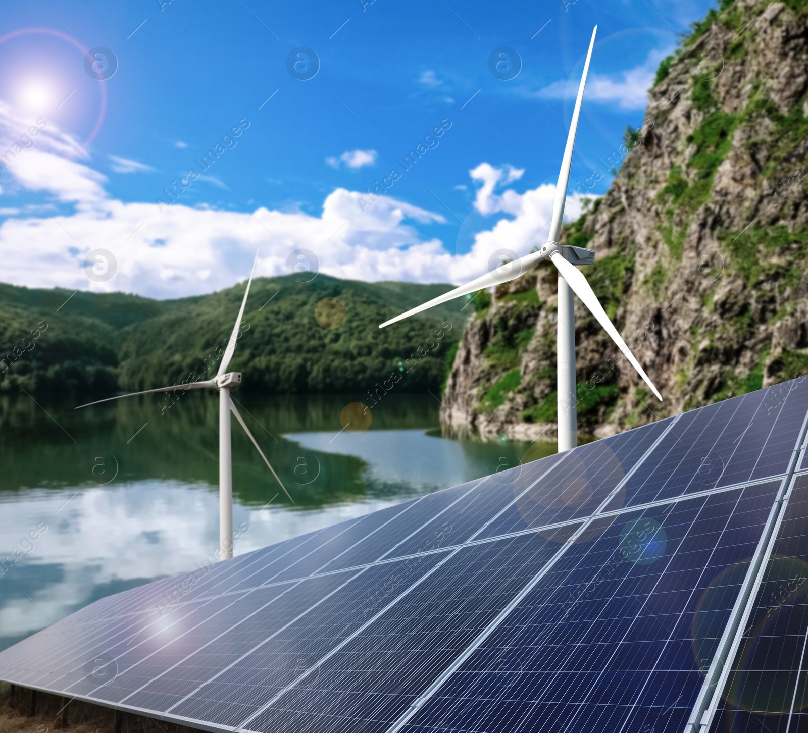 Image of Alternative energy sources. Wind turbines installed in water, solar panels on foreground