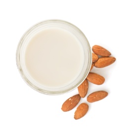 Jar with almond milk and nuts on white background, top view