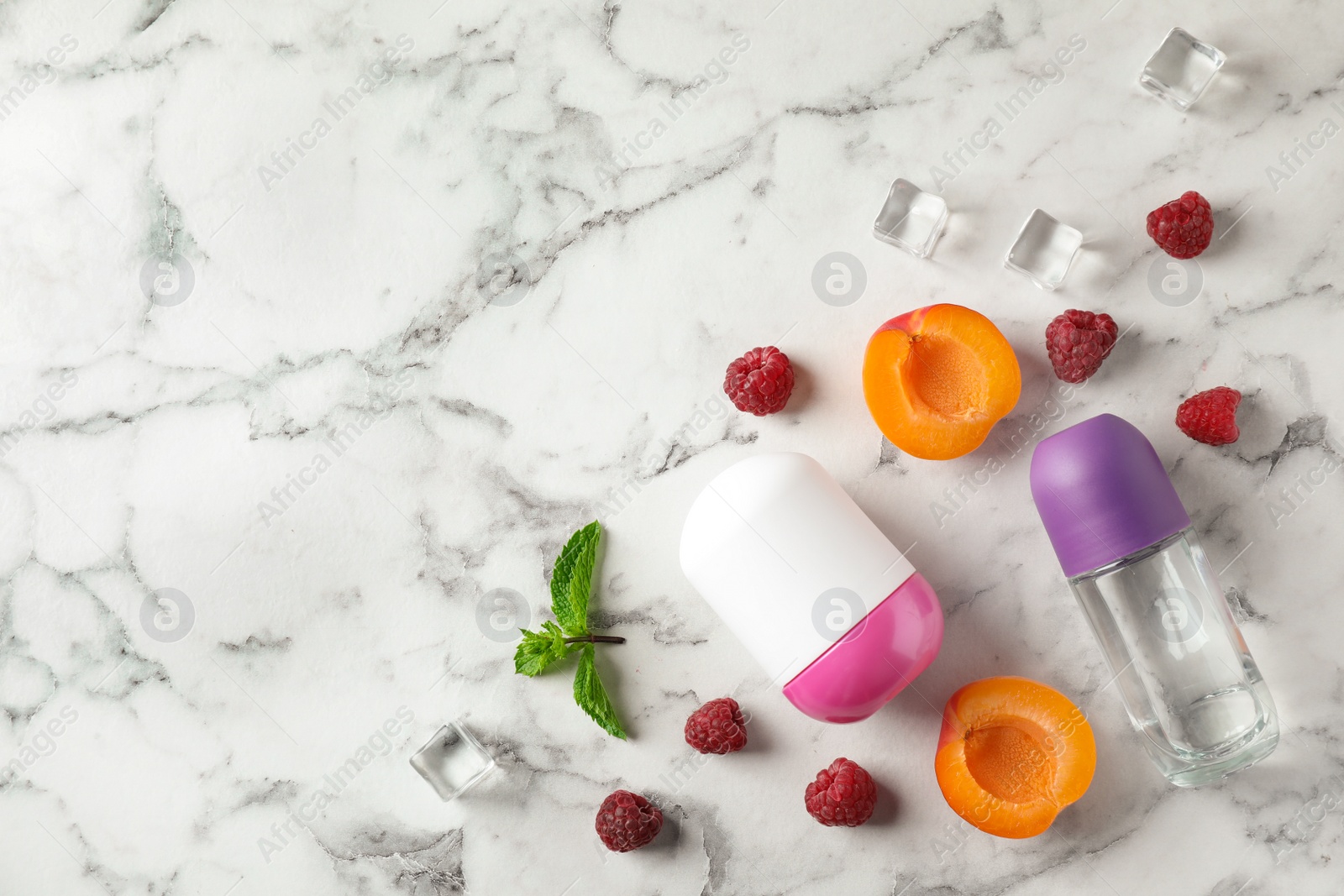 Photo of Flat lay composition with natural deodorants on white marble table. Space for text