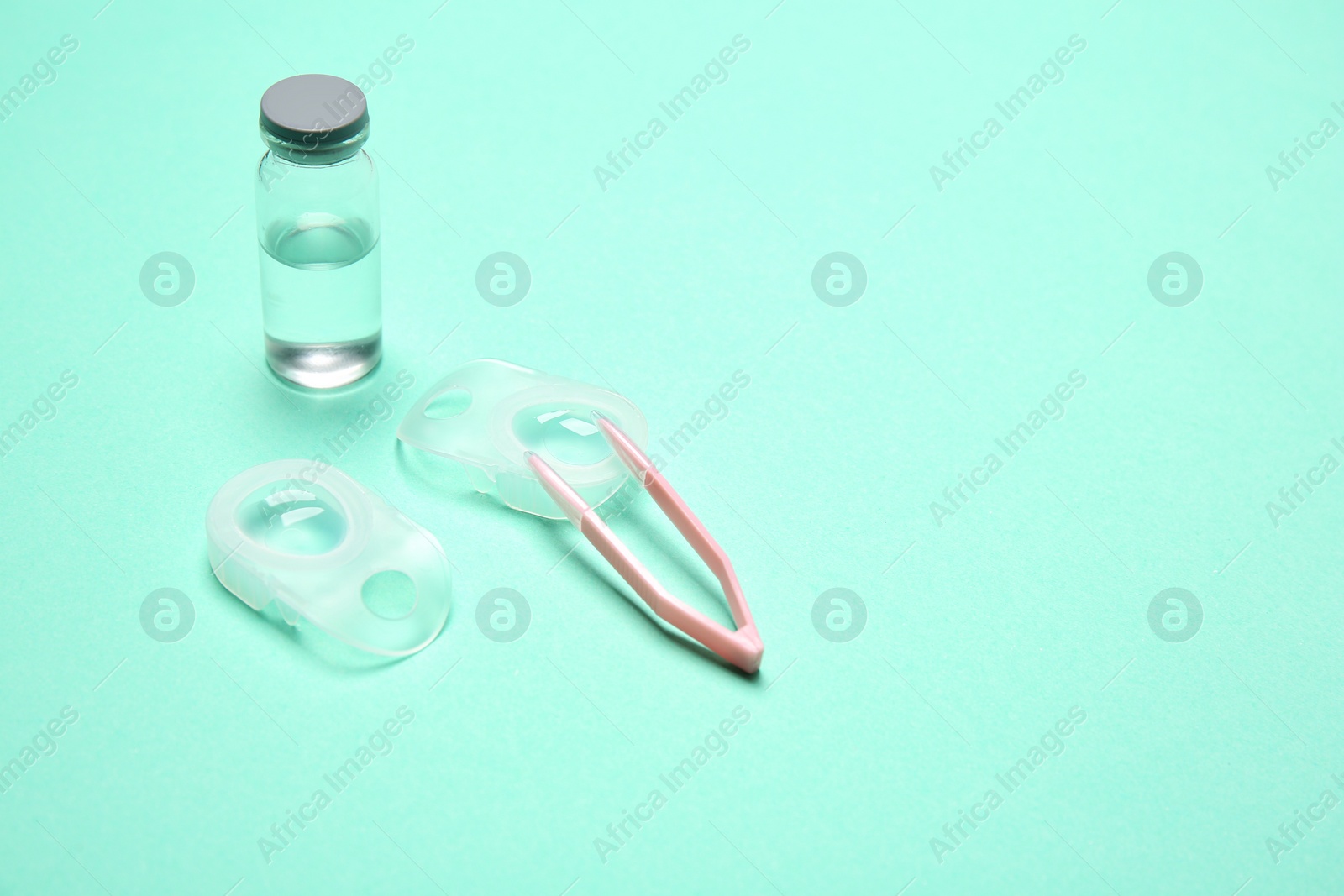 Photo of Contact lenses and accessories on color background