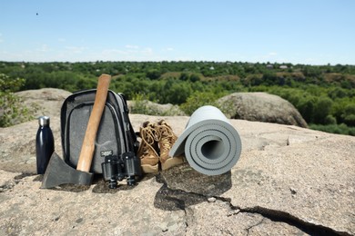 Photo of Set of camping equipment on rock outdoors