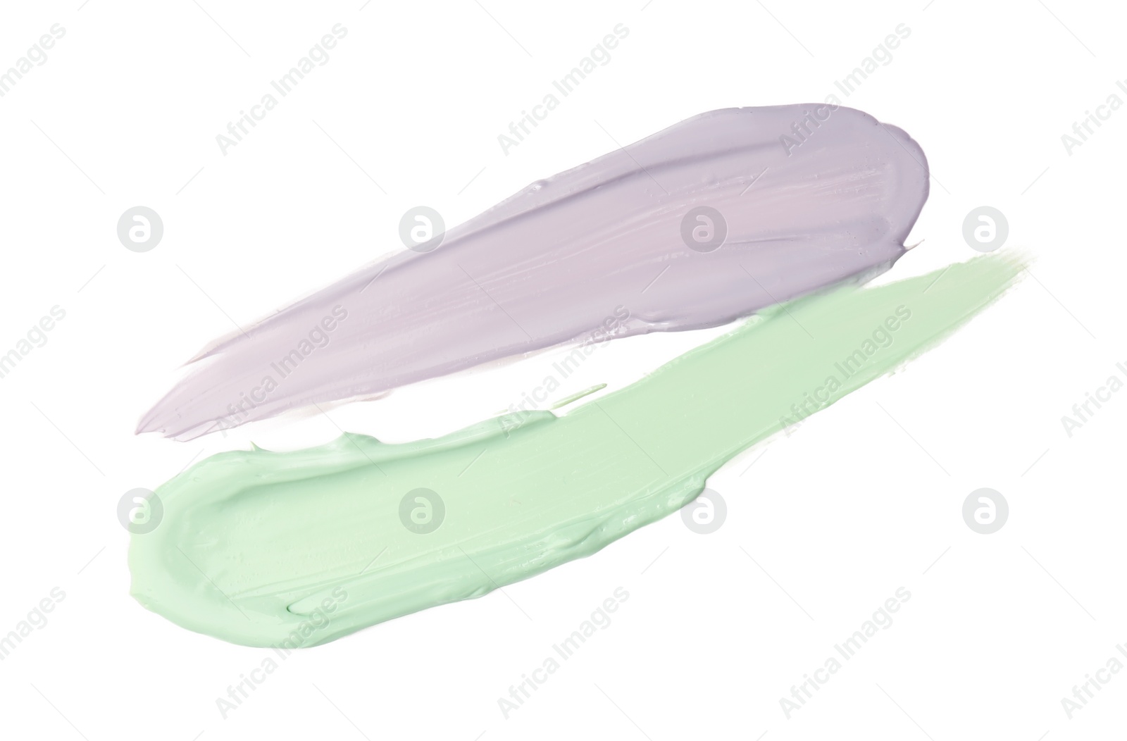 Photo of Strokes of green and purple color correcting concealers isolated on white, top view