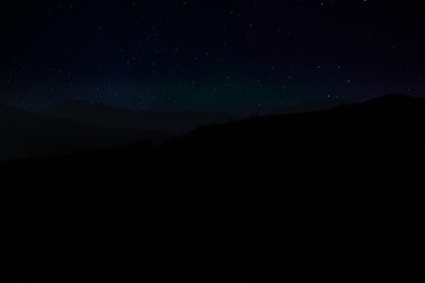 Image of Beautiful view of starry sky over mountains at night