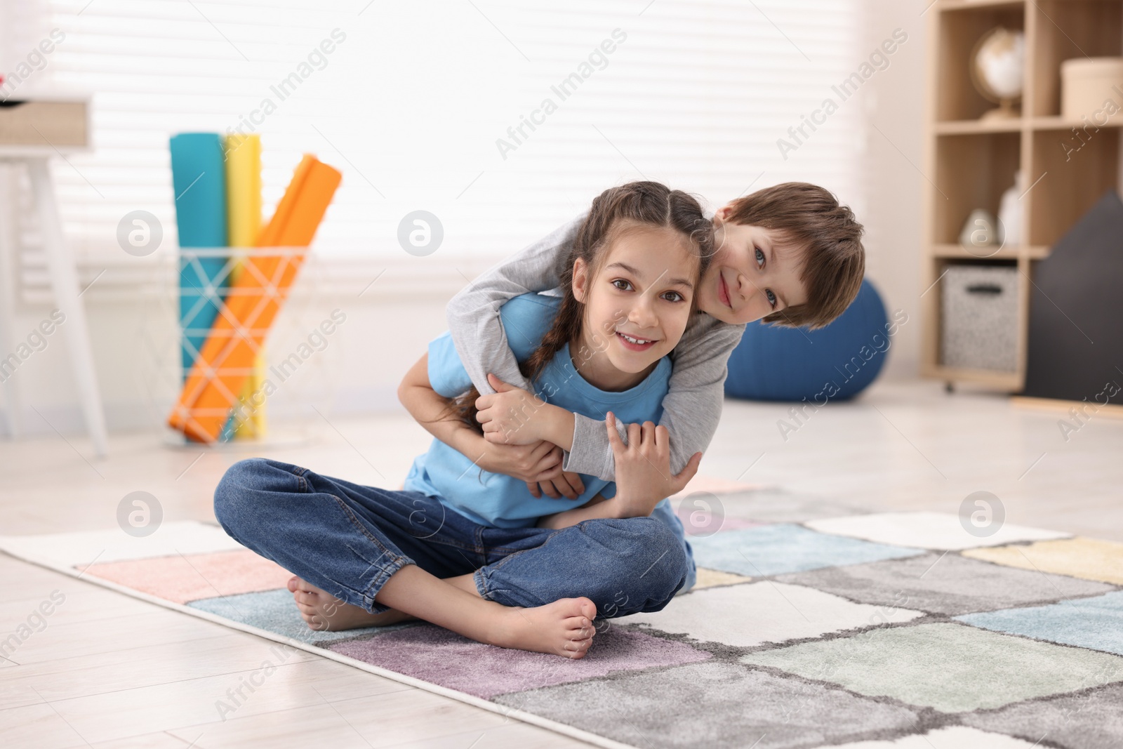 Photo of Happy brother and sister spending time together at home