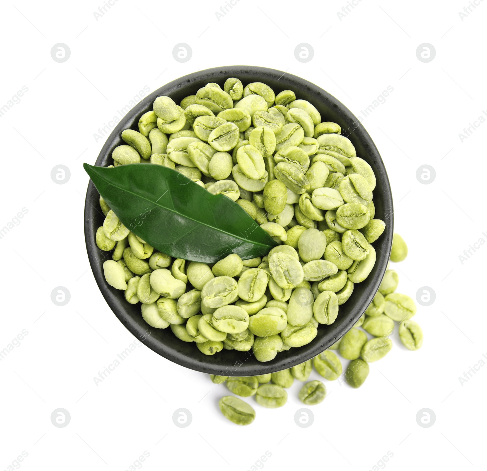 Photo of Bowl with green coffee beans and fresh leaf on white background, top view