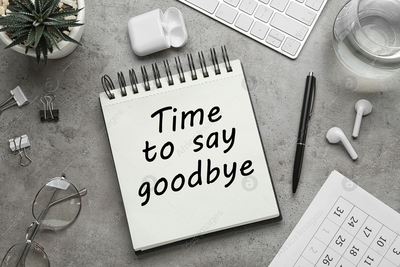 Image of Notebook with text Time to say goodbye on grey table, flat lay